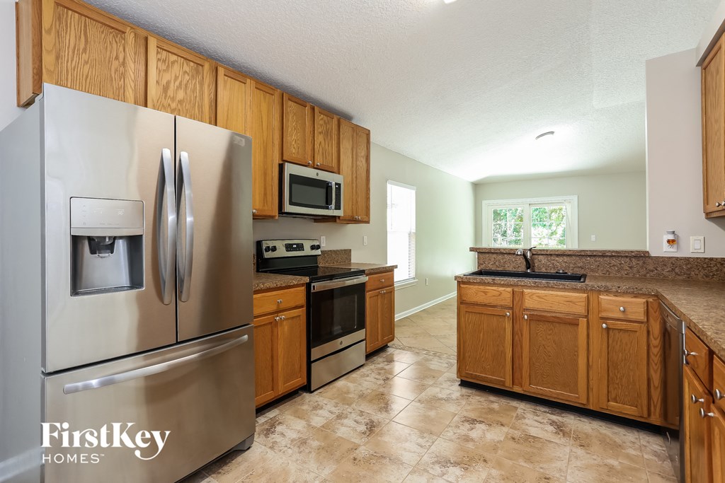 a kitchen with stainless steel appliances and wooden cabinets