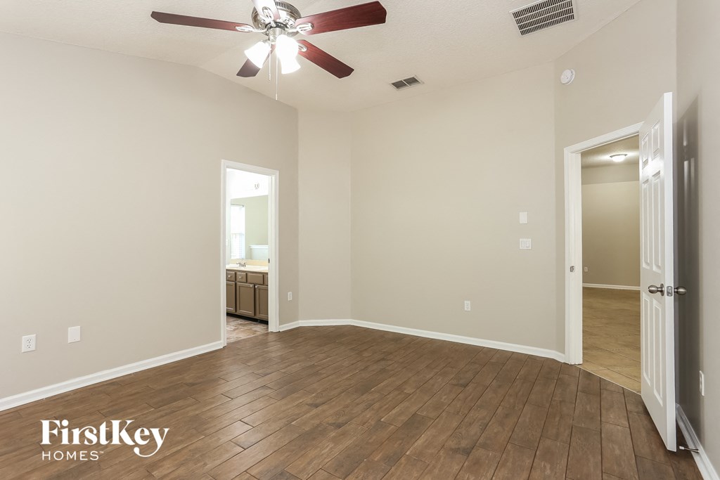 a living room with a wood floor and a ceiling fan