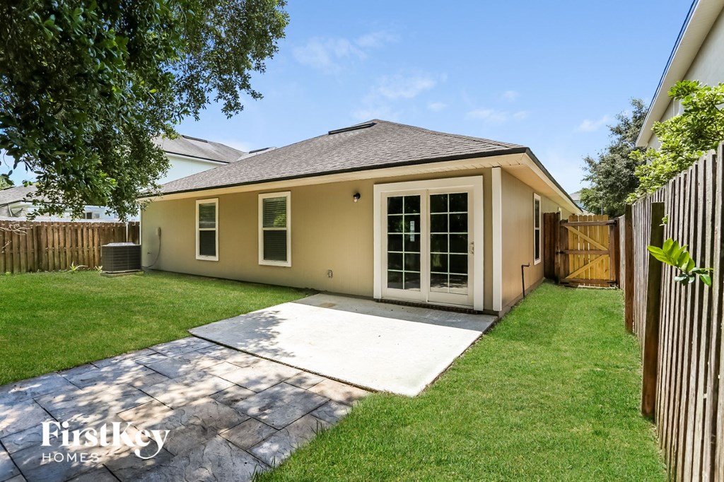 a backyard with a patio and a house