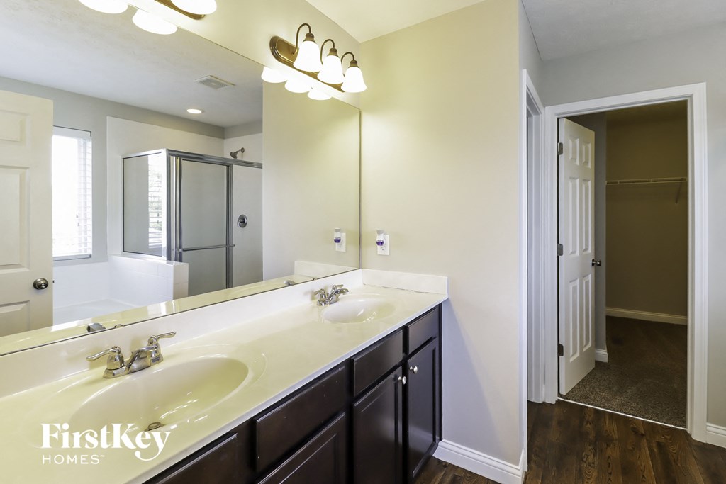 a bathroom with two sinks and a large mirror