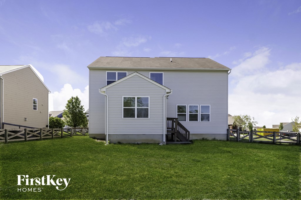 a white house with a yard in front of it