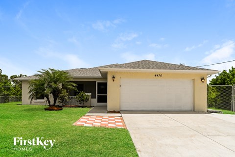 a house with a garage and a palm tree
