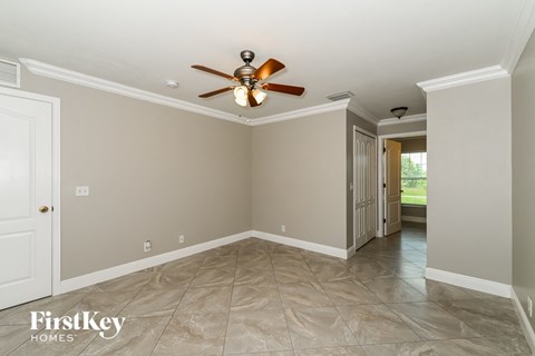 a dining room with a ceiling fan and tile flooring