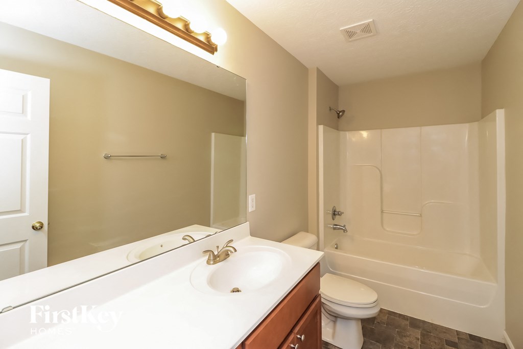 a bathroom with a sink and a toilet and a shower