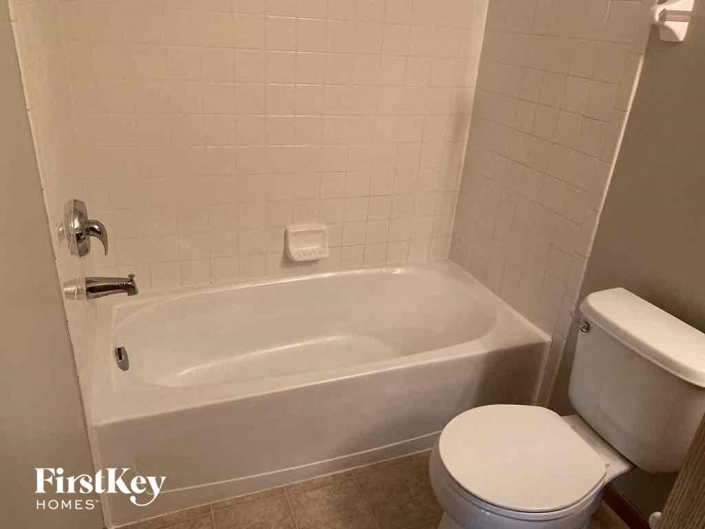 a bathroom with a toilet and a bath tub