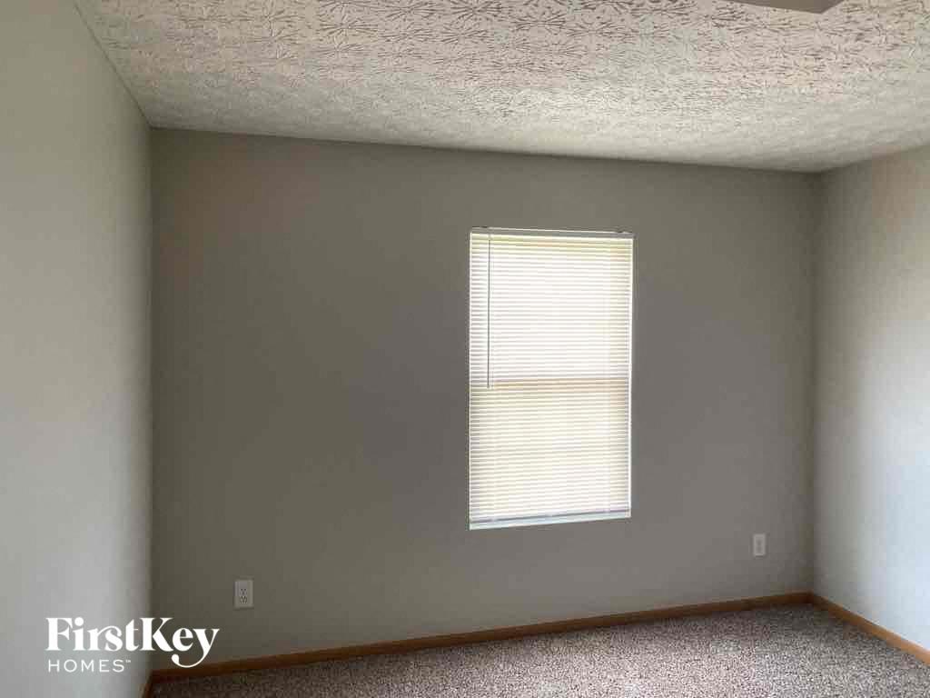 an empty room with white walls and a window