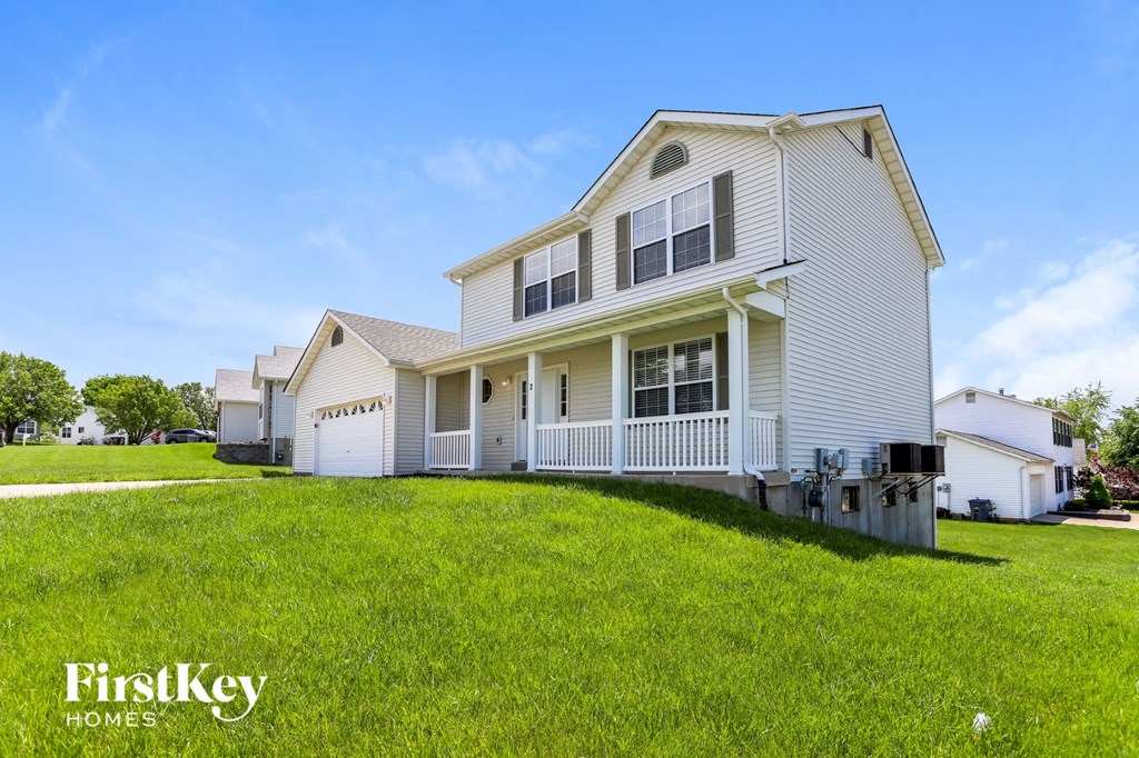 a white house with a yard in front of it