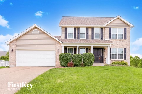 a brick house with a lawn in front of it