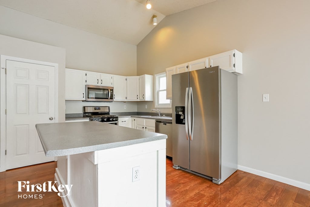 a kitchen with stainless steel appliances and white cabinets