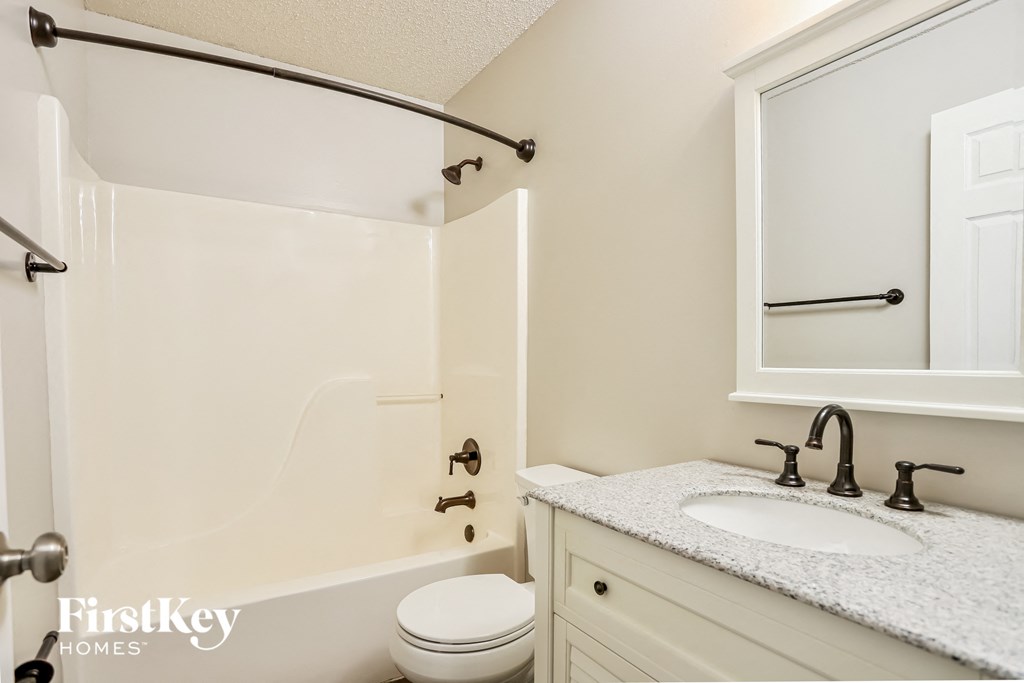 a bathroom with a shower and a sink and a toilet