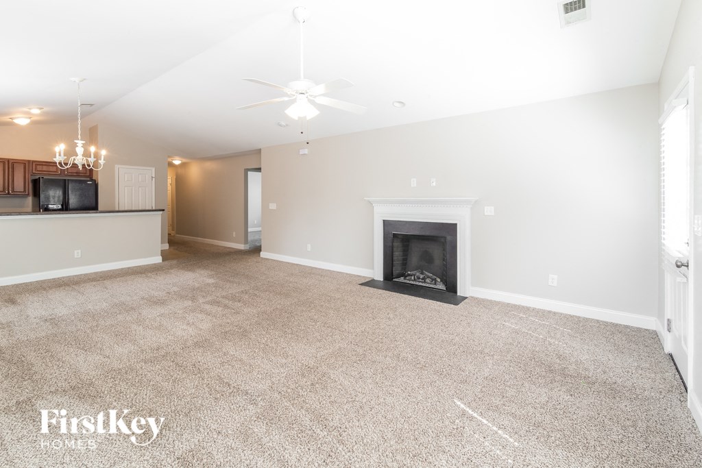 A living room with a fireplace and a television.