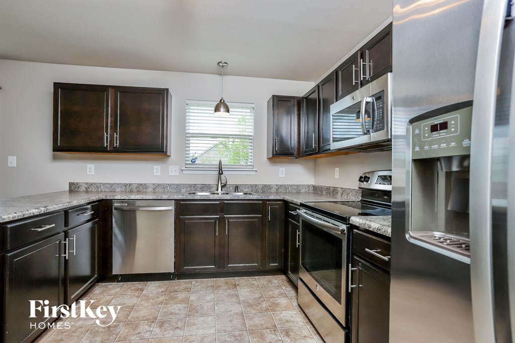 a kitchen with stainless steel appliances and granite counter tops