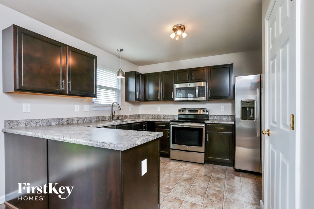 a kitchen with stainless steel appliances and granite counter tops