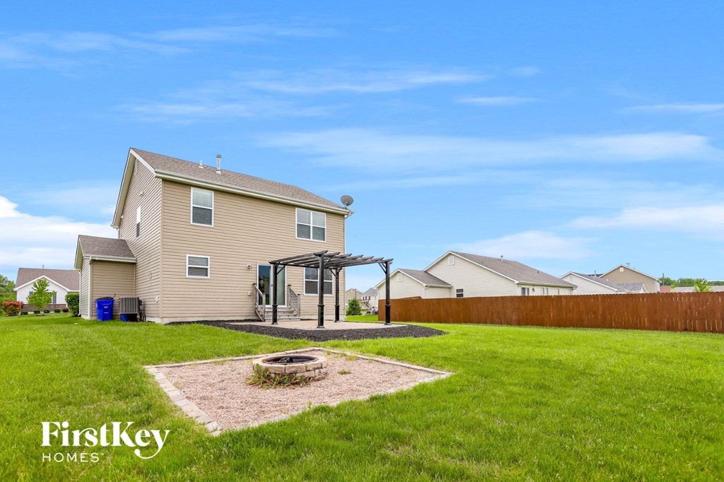 a backyard with a house and a backyard grill