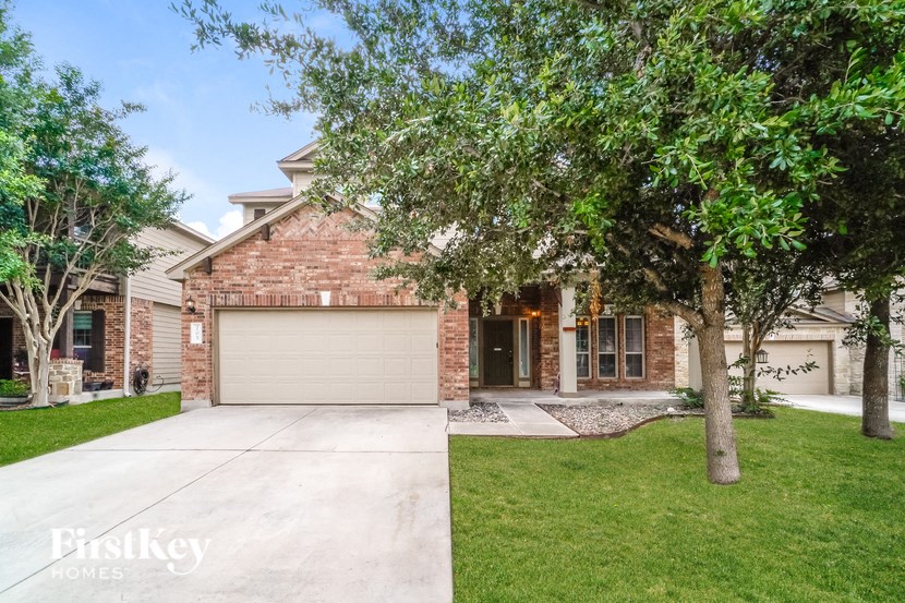 A brick house with a garage door is for sale.