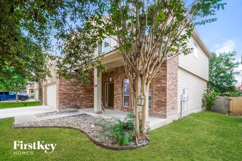 A house with a tree in front of it.