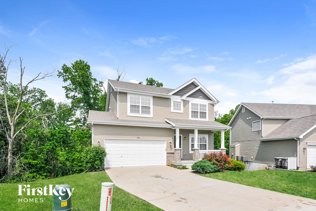 a house with a white garage door and a driveway