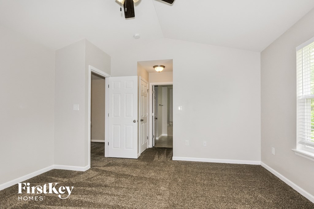a living room with a carpeted floor and white walls