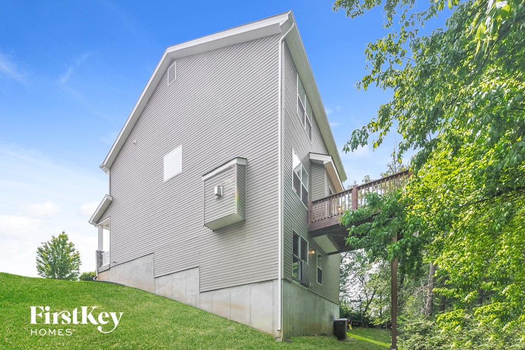 a house with a deck on top of a hill