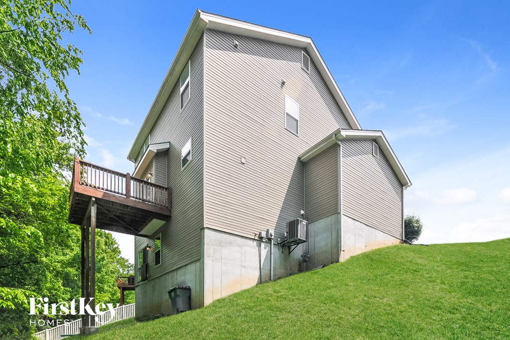 a large house on a hill with a green lawn