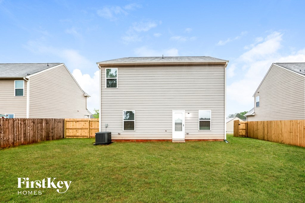 A house with a fence and a grassy yard.