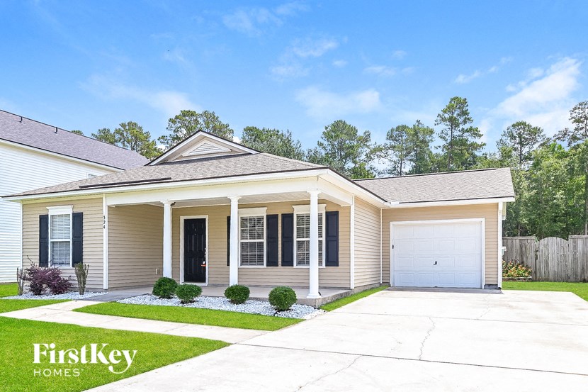 a beige house with a garage and a driveway