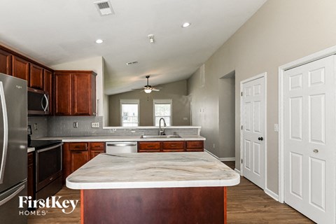 a kitchen with a marble counter top in the center of it