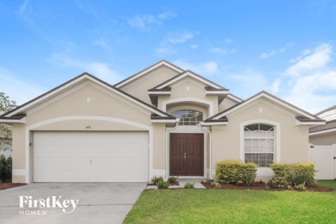A house with a garage and a brown door.
