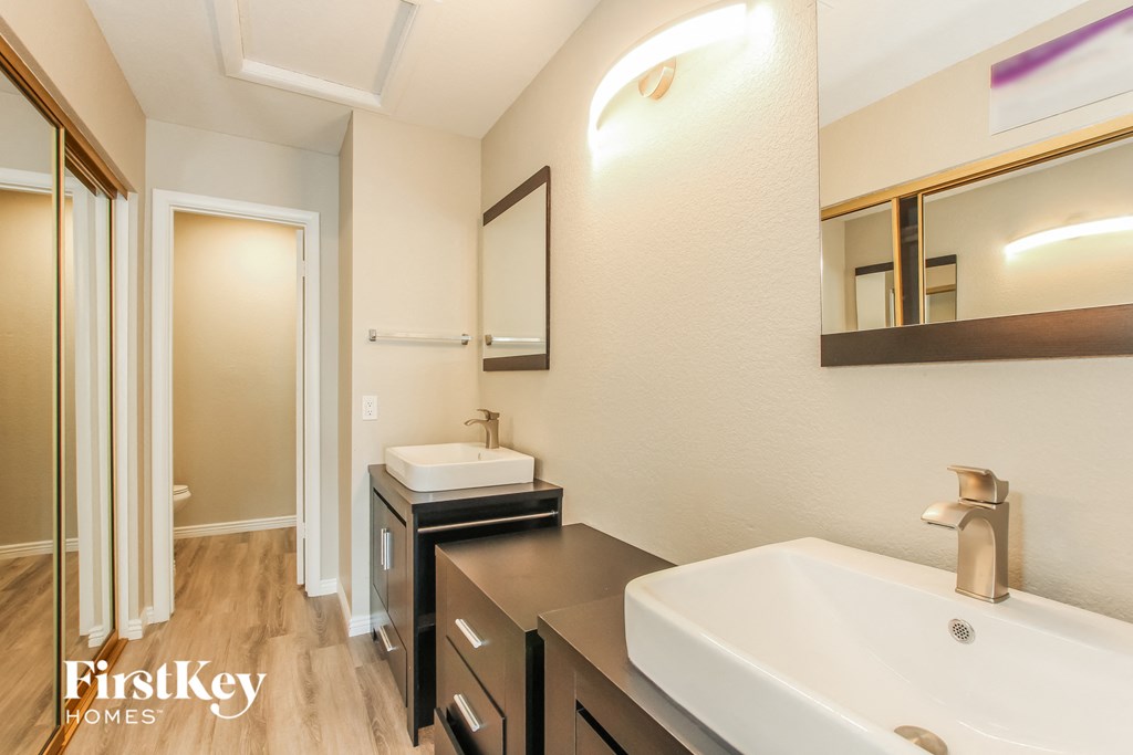 a bathroom with a sink and a mirror and a shower