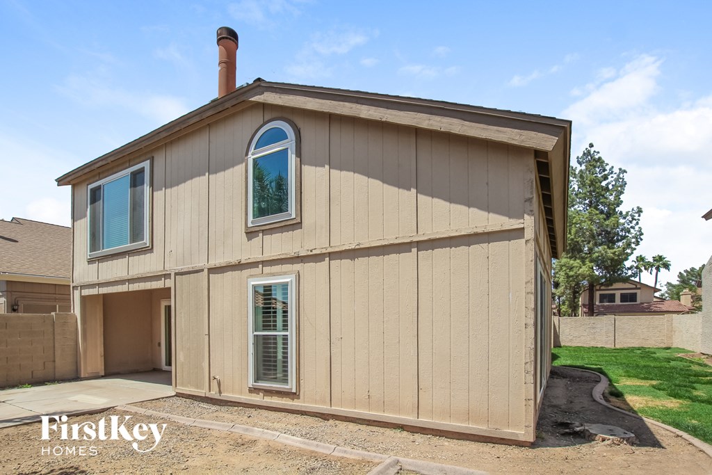 the view of the front of the house with the garage door open