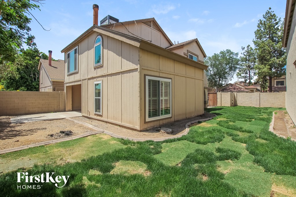 the back of a house with a yard and grass