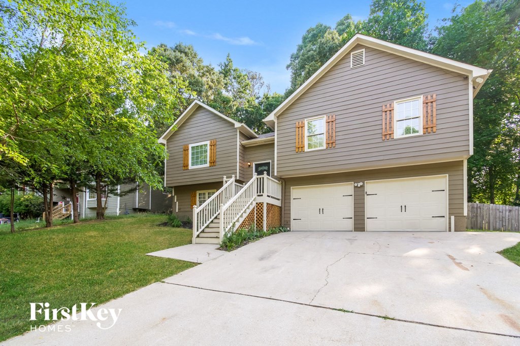 A two-story house with a garage is for sale.