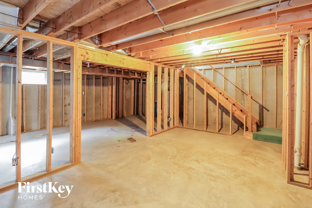 A room under construction with wooden framing and a staircase.