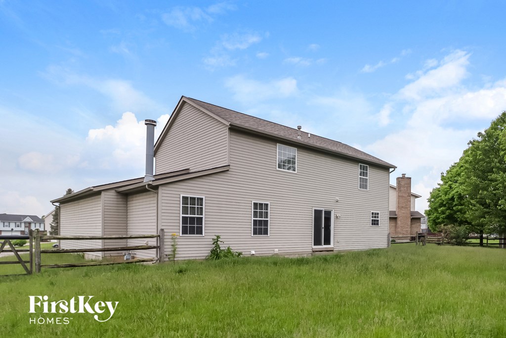 A house with a fence in front of it.