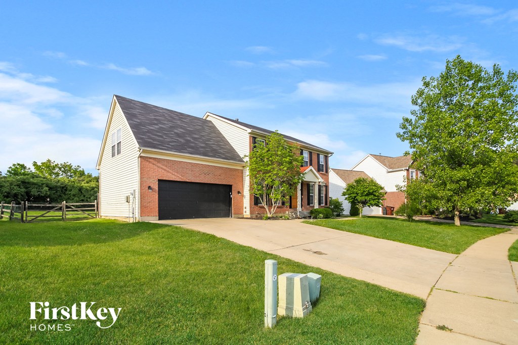 A house with a garage and a driveway is shown with the words "FirstKey Homes" on the bottom left.