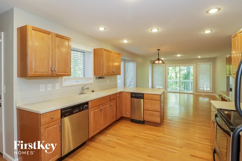 a kitchen with wooden cabinets and a white counter top