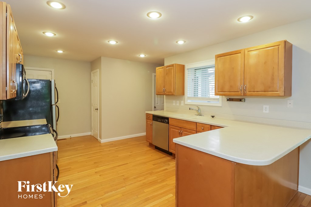 a kitchen with wooden cabinets and a white counter top