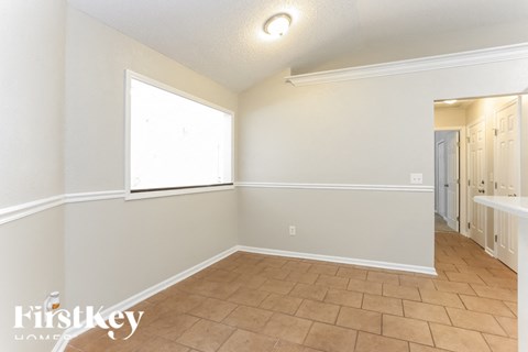 A room with a tile floor and a window.