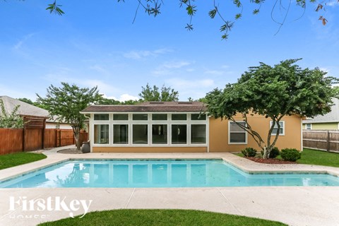 A house with a pool in the backyard.