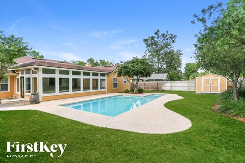A house with a pool in the backyard.