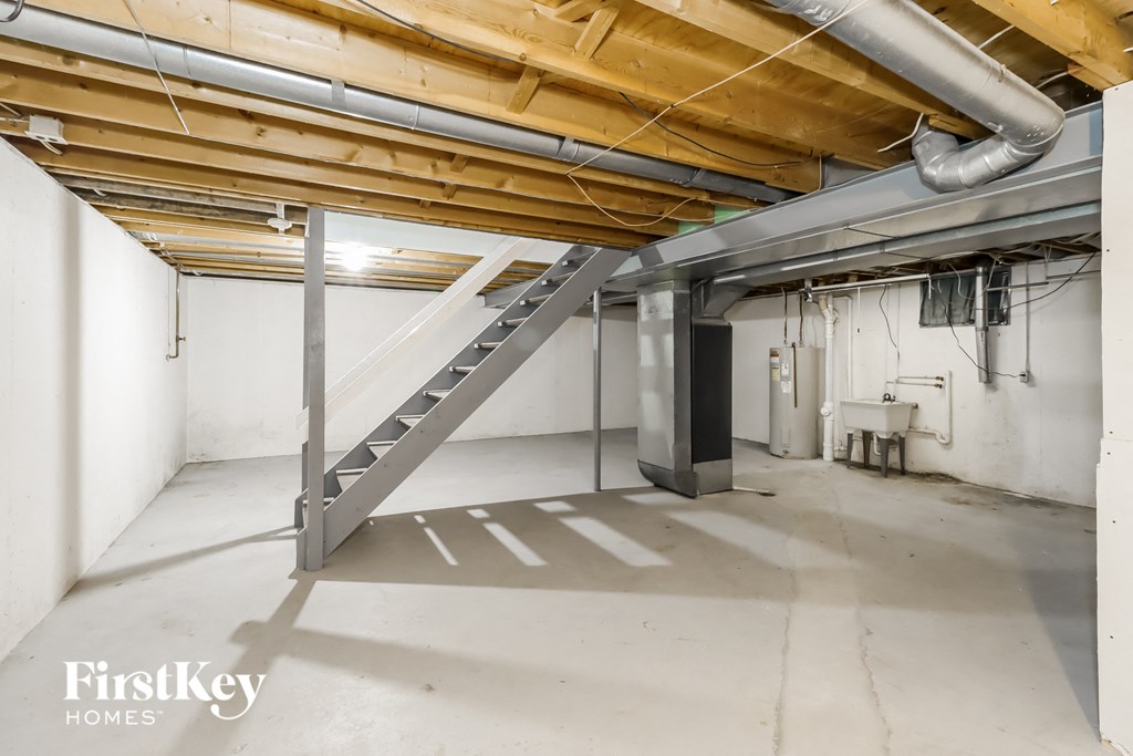 a basement with a staircase in the middle