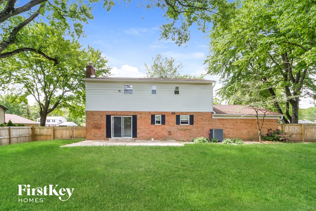 a brick and with a yard and a fence