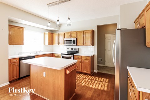a kitchen with wooden cabinets and stainless steel appliances