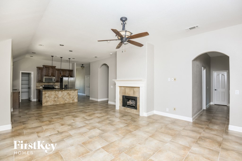 the living room is open to the kitchen and dining room