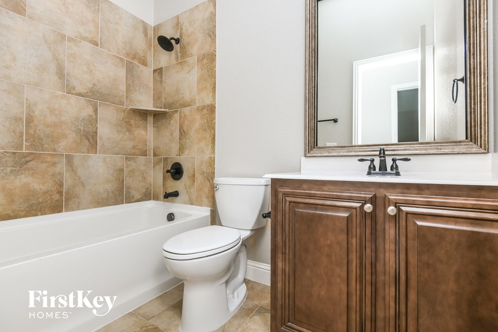 a bathroom with a toilet and a sink and a bath tub