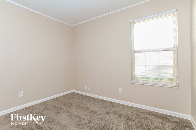 a room with a carpeted floor and a window