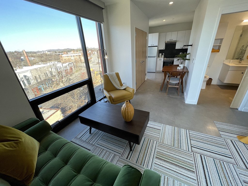 a view of the living room and kitchen of an apartment
