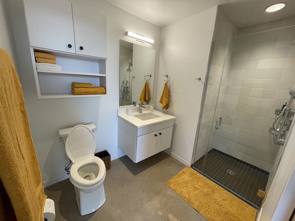 a bathroom with a toilet sink and shower