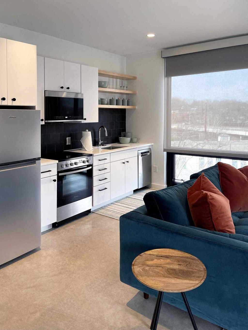 a kitchen and living room with a blue couch