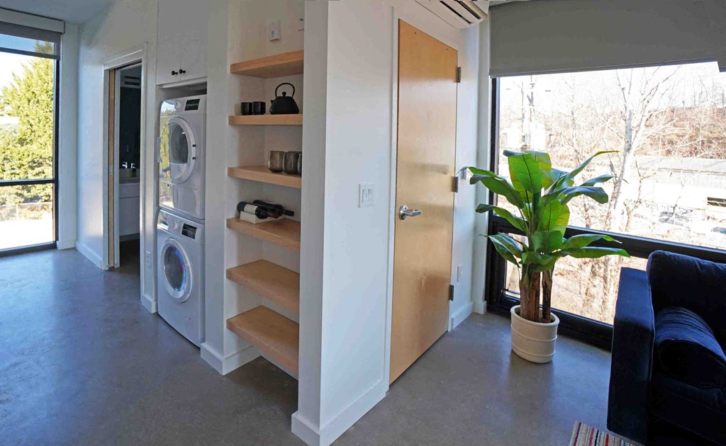 a modern laundry room with a washer and dryer in a house